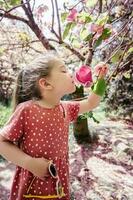 een meisje houdt een takje van magnolia. foto