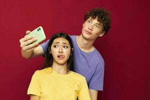 mooi hoor vent en meisje in kleurrijk t-shirts met een telefoon jeugd stijl foto