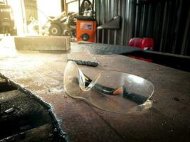 transparant veiligheid bril geplaatst Aan staal werk veiligheid foto