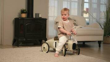 gelukkig kind Bij huis. weinig kleuter jongen het rijden groot wijnoogst speelgoed- auto en hebben plezier. glimlachen kind spelen Bij huis. baby jongen spelen met speelgoed- in leven kamer binnenshuis. foto