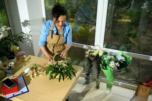 visie van bovenstaand van een zwanger vrouw bloemist regelen van een boeket van bloemen voor feestelijk leven evenement in bloemen winkel. foto