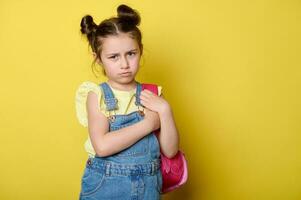 bedroefd, overweldigd schoolmeisje, eerste grader Holding haar roze rugzak, uitdrukken verdrietig emoties, op zoek Bij camera foto