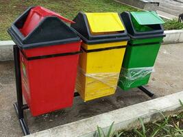 kleurrijk afval doos in een park in de midden- van de stad foto