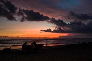 zonsondergang op het strand van pantai batu bolong op bali in indonesië foto