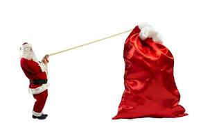 de kerstman claus trekt een touw naar Actie een groot zak vol van cadeaus foto