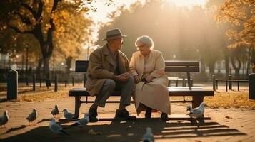 grootouders dag. een ouderen paar in de park Aan een bank voeden duiven. ai gegenereerd. foto