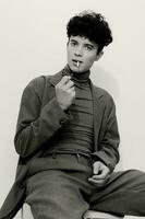 leerling Mens zittend en zwart wit sigaret attent portret roken hipster mode Kaukasisch foto
