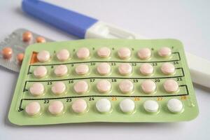 zwangerschap test en geboorte controle pillen Aan kalender, anticonceptie Gezondheid en geneesmiddel. foto