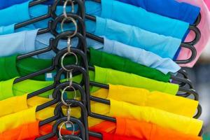 close-up van kleurrijke t-shirts op hangers
