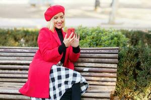 optimistisch vrouw scrollen sociaal media in park foto
