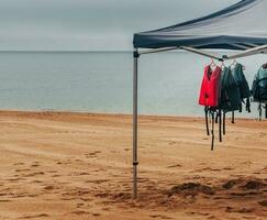 leven jassen hangende Aan een hanger De volgende naar een leeg strand foto