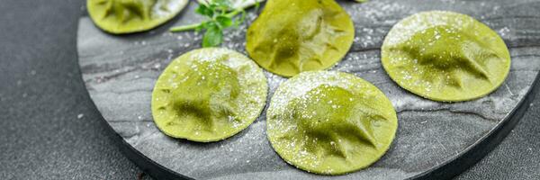 groen ravioli groen deeg spinazie, basilicum groente voedsel gezond maaltijd voedsel tussendoortje Aan de tafel kopiëren ruimte voedsel achtergrond rustiek top visie foto