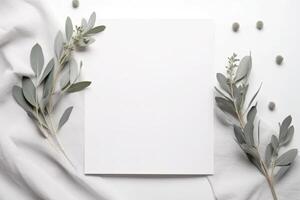 blanco groet papier kaart, uitnodiging mockup tafereel top visie met eucalyptus boom takken. elegant schrijfbehoeften Aan wit tafel achtergrond. ai gegenereerd foto