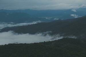 berg reeks met zichtbaar silhouetten door de ochtend- blauw mist. foto