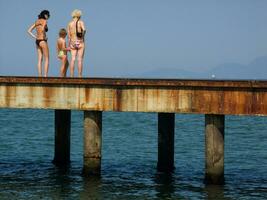 twee Dames wandelen Aan een pier foto