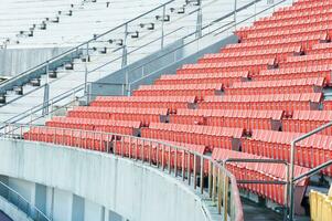 leeg oranje stoelen Bij stadion, rijen loopbrug van stoel Aan een voetbal stadion foto