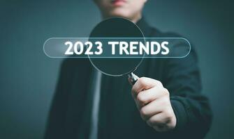 zakenman hand- gebruik vergroten glas zoeken voor 2023 trends informatie. gebruik makend van zoeken troosten voor trends gegevens, informatie, zoeken Aan virtueel scherm gegevens zoeken technologie zoeken motor optimalisatie. foto