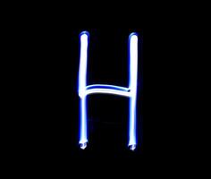 h hotel alfabet hand- schrijven blauw licht over- zwart achtergrond. foto