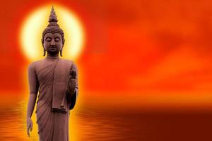 de boeddha staat sierlijk op een lotusbloem met een oranje achtergrond. over boeddhisme foto