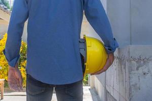 ingenieur die veiligheidshelm op bouwplaats houdt foto