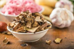 droog champignons verzuren kool knoflook en aardappelen Aan houten tafel foto