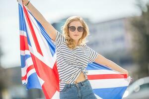 aantrekkelijk gelukkig jong meisje met de vlag van de Super goed Brittannië foto