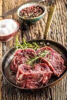 detailopname plakjes van rundvlees varkenshaas steak zout peper en rozemarijn foto
