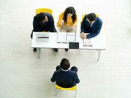 baan interview concept. verschillend hr team aan het doen baan interview met een Mens in bedrijf kantoor. menselijk middelen team afnemen van interviews een potentieel baan kandidaat. in dienst nemen, werkgelegenheid, en werving concept. foto