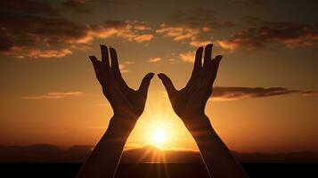 handen in afdaling zonsondergangen achter verheven vrouw handen. silhouet concept foto