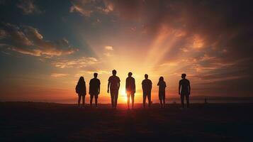 groep van vrienden aftekenen tegen een zonsondergang foto