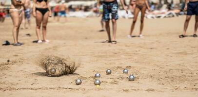 petanque ballen in de zand door de zee gedurende een spel Aan de strand foto