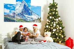 familie in bed Bij Kerstmis foto