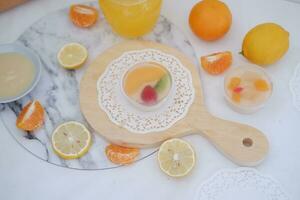 fruit gelei met oranje sap, citroen en kiwi Aan de tafel foto