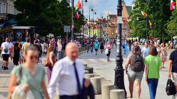 Warschau, Polen. 29 juli 2023. menigte van mensen wandelen Aan een straat. een menigte in beweging tegen een achtergrond van een stedelijk oud stad landschap. foto