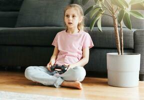 meisje spelen video spel Bij huis foto