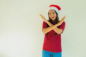 portret mooie jonge aziatische vrouwen die een kerstmuts dragen voor een feest in kerstmis foto