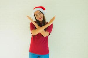 portret mooie jonge aziatische vrouwen die een kerstmuts dragen voor een feest in kerstmis foto