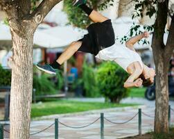 jong atleet aan het doen extreem acrobatiek buitenshuis foto