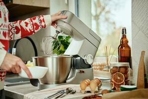 vrouw Koken Bij huis keuken, gebruik elektrisch menger naar voorbereidingen treffen deeg foto