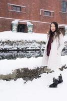 mooie jonge aziatische vrouw glimlach en blij met reisreis in otaru canal hokkaido japan foto