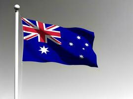 Australië nationaal vlag golvend Aan grijs achtergrond foto