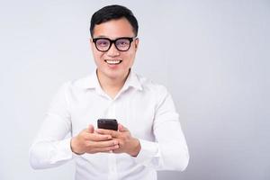 Aziatische zakenman die smartphone op witte achtergrond gebruikt