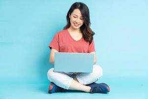 mooie aziatische vrouw zitten werken met laptop