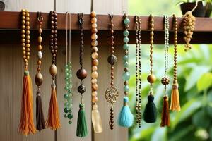 een verzameling van mala gebed kralen - jade, sandelhout, rudraksha zaden - hangende decoratief Aan een plank. ai gegenereerd. foto