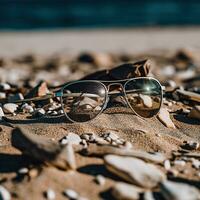 een paar- van zonnebril zittend Aan top van een zanderig strand foto