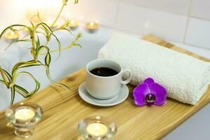 spa-schoonheid salon, welzijn centrum. aromatherapie spa behandeling voor de vrouw lichaam in de badkamer met een kop van koffie, kaarsen, oliën en zout. foto
