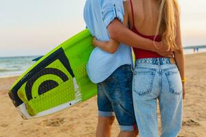 jong paar hebben pret Aan strand wandelen met surfen bord foto