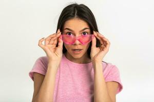 aantrekkelijk vrouw in roze t-shirt en zonnebril foto