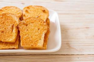 gebakken krokant brood met boter en suiker op bord foto