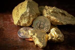 gouden bitcoin fysieke bitcoin cryptocurrency en goudklompkorrels. foto